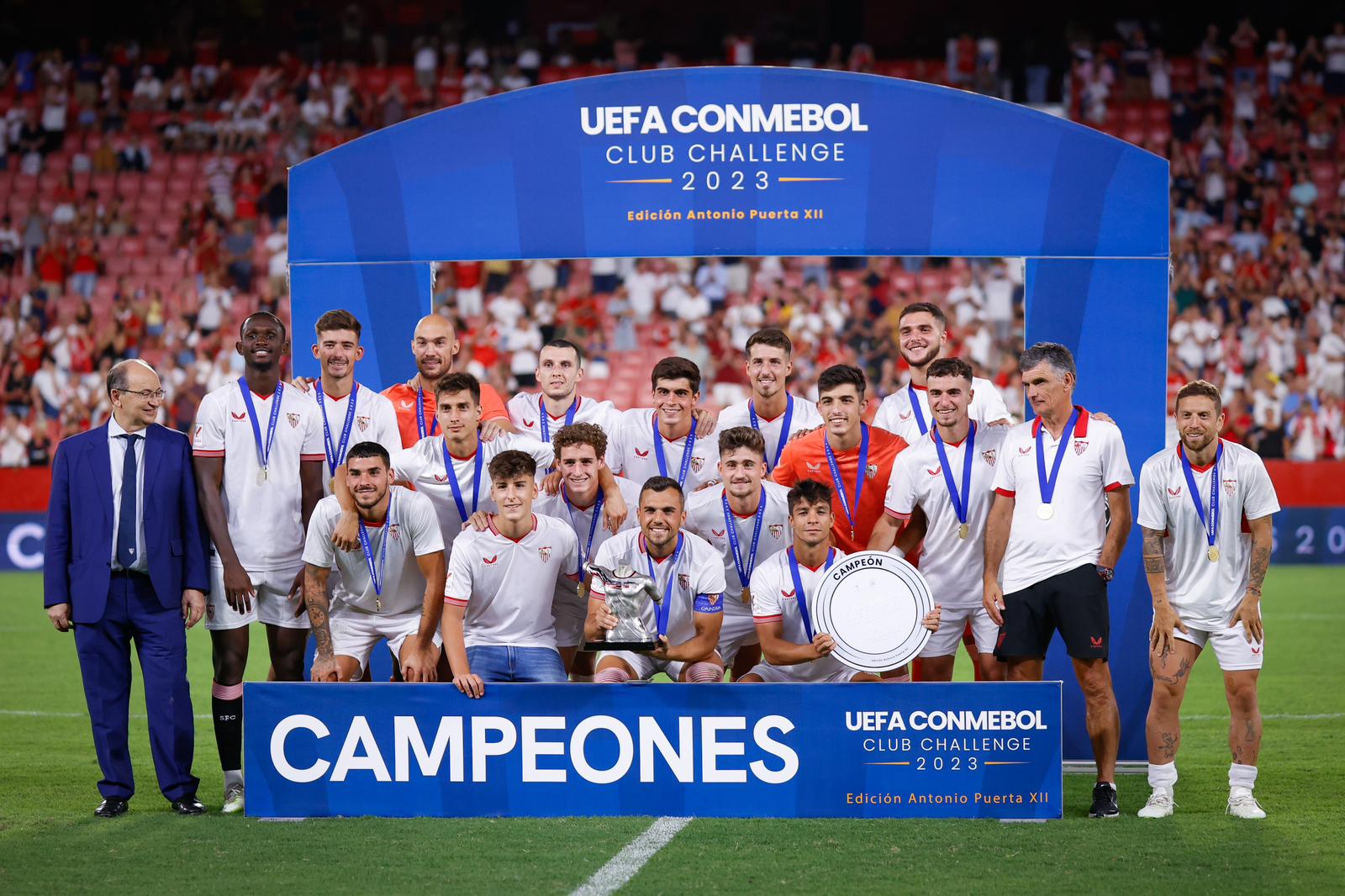 Sevilla FC pose with the Antonio Puerta Trophy and the UEFA CONMEBOL Club Challenge